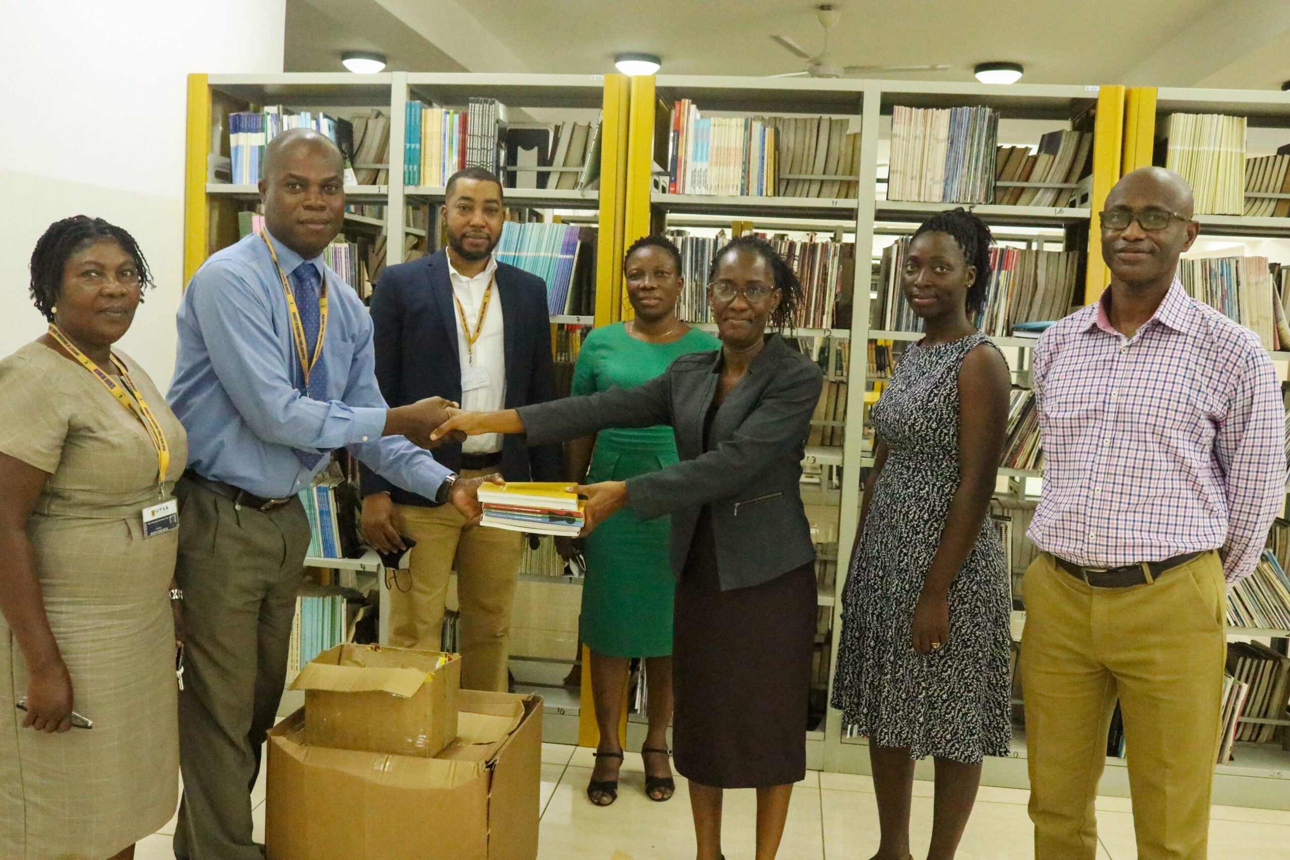 Prof. Amankwah and colleagues presenting donated books at the UPSA Library